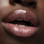 Milani lip gloss bundle shades swatched on skin demonstrating the sheer glossy finish.