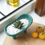 Dodococa ceramic mini bathtub showing bottom drainage holes