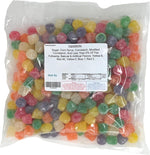Assorted cinnamon clove and anise flavored chewy gumdrops piled in a decorative glass candy dish.
