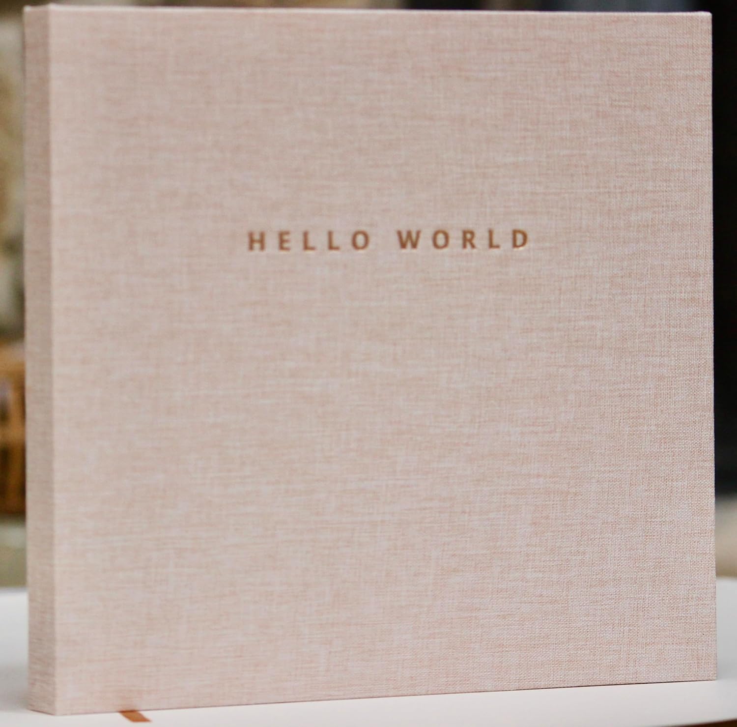 Joss & Lac Design linen baby memory book front view featuring hello world embossed text