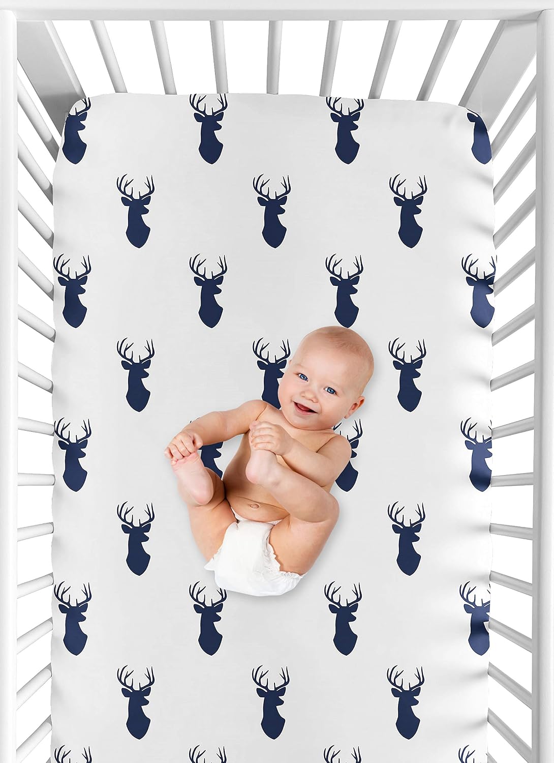 Standard crib mattress styled with forest animal theme sheet