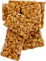 Rich golden brown peanut brittle chunks showing roasted peanuts embedded