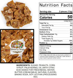 Close up view of crunchy old fashioned peanut brittle pieces loaded with roasted peanuts