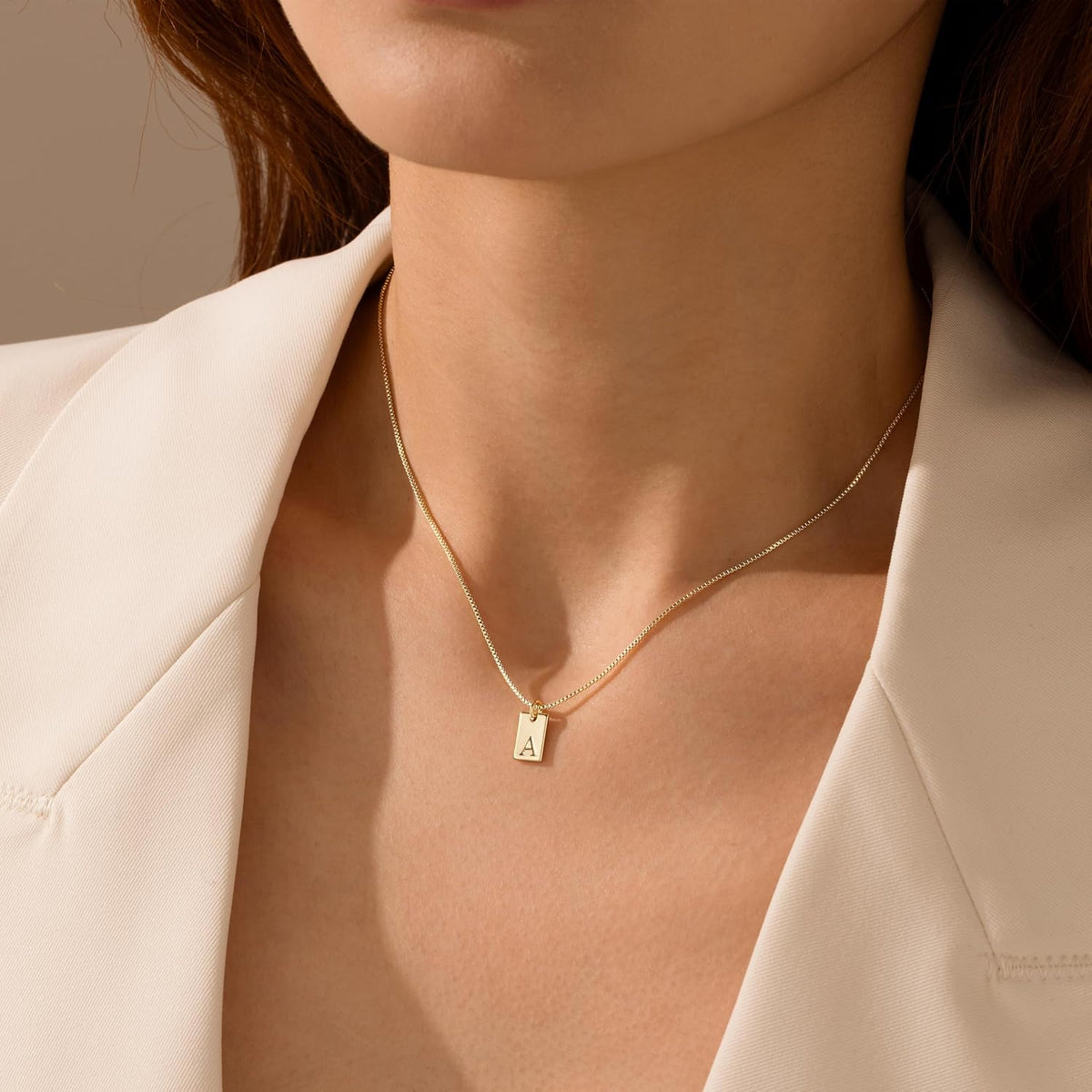 Model wearing the waterproof non-tarnish initial necklace as a choker