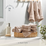 Folded stack of Belador beige bathroom wash cloths on a wooden shelf