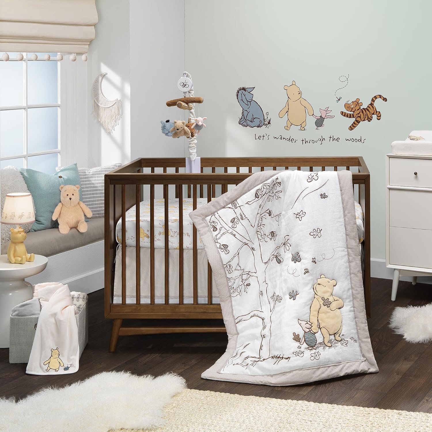 Lambs And Ivy Disney Baby Storytime Pooh Crib Bedding Set front view of embroidered quilt inside premium nursery setup