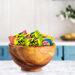 Red fish shaped chewy candy and fruit flavored snack assortment close up