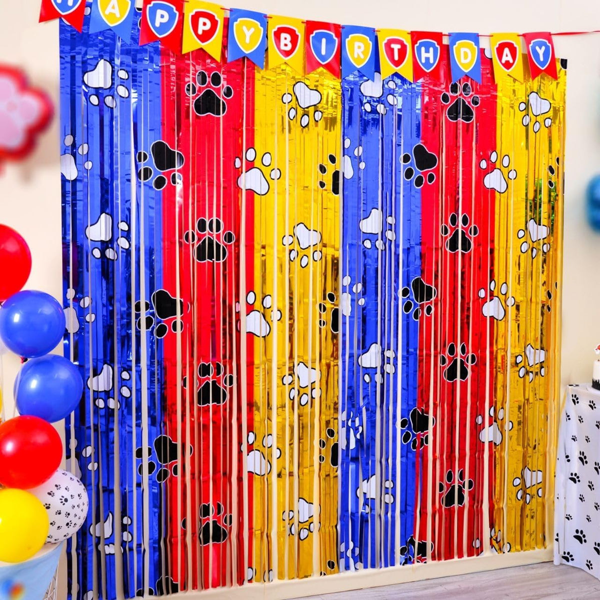 Bupelo Paw Birthday Party Decorations front view showing gold red and blue tinsel foil fringe curtains with paw prints.