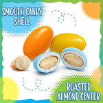 Gourmet sweet and bitter candy-coated almonds poured into a glass party display bowl.