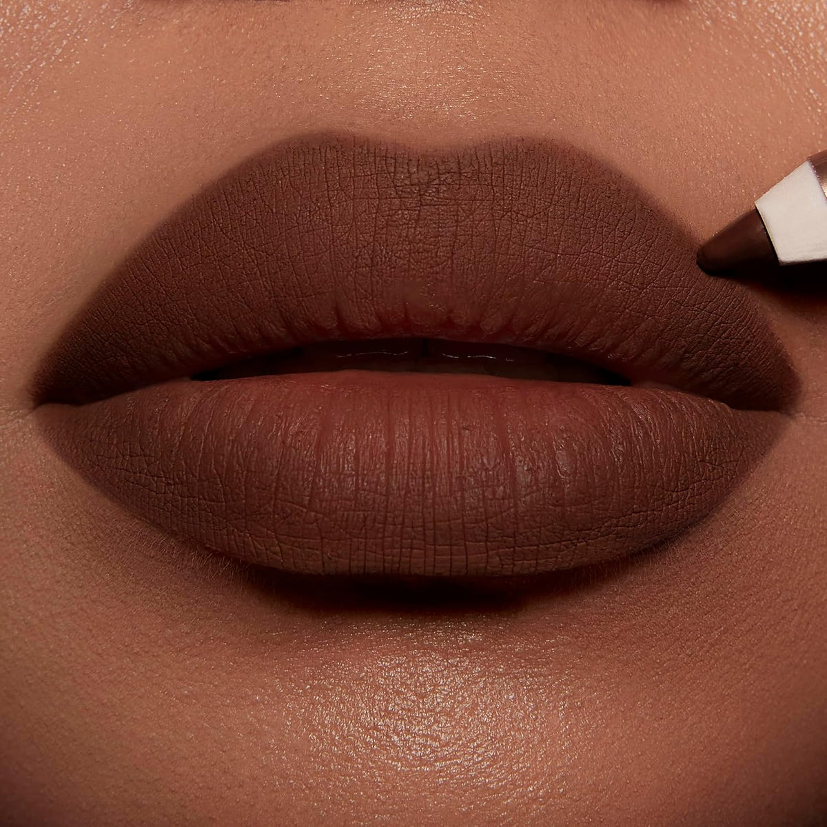 Creamy matte lip liner pencil showing the rich suede brown shade.