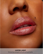 Milani prismatic lip topping glitter applied on bare skin showcasing multi dimensional shifting pearls
