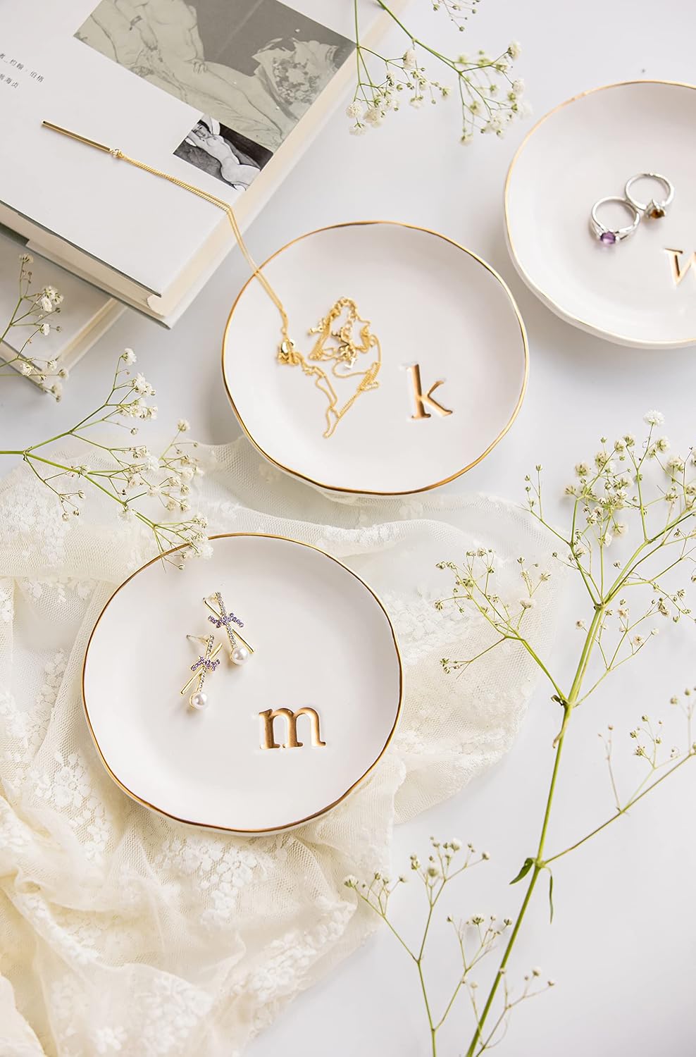 Close up of embossed gold monogram letter k on white ceramic