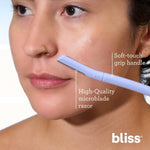 Model demonstrating safe usage of Bliss dermaplaning razor on cheek