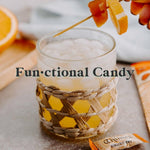 Chimes Meyer Lemon Ginger Chews bulk bag standing upright alongside raw ginger root