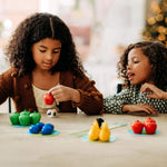 Toddler playing HABA First Orchard cooperative game