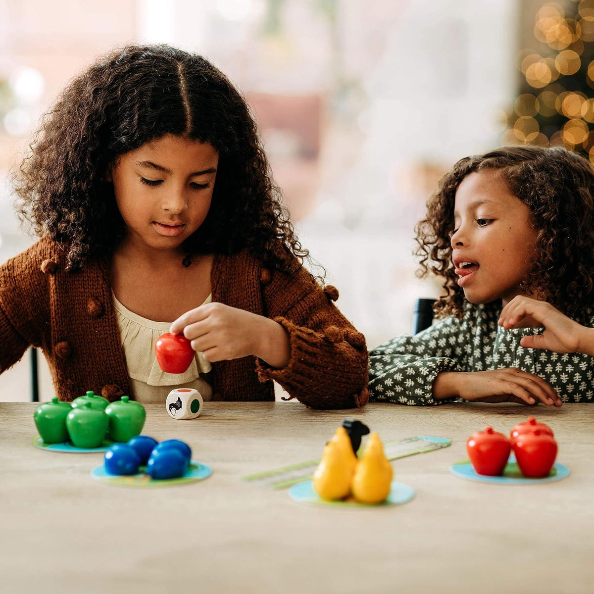 Toddler playing HABA First Orchard cooperative game