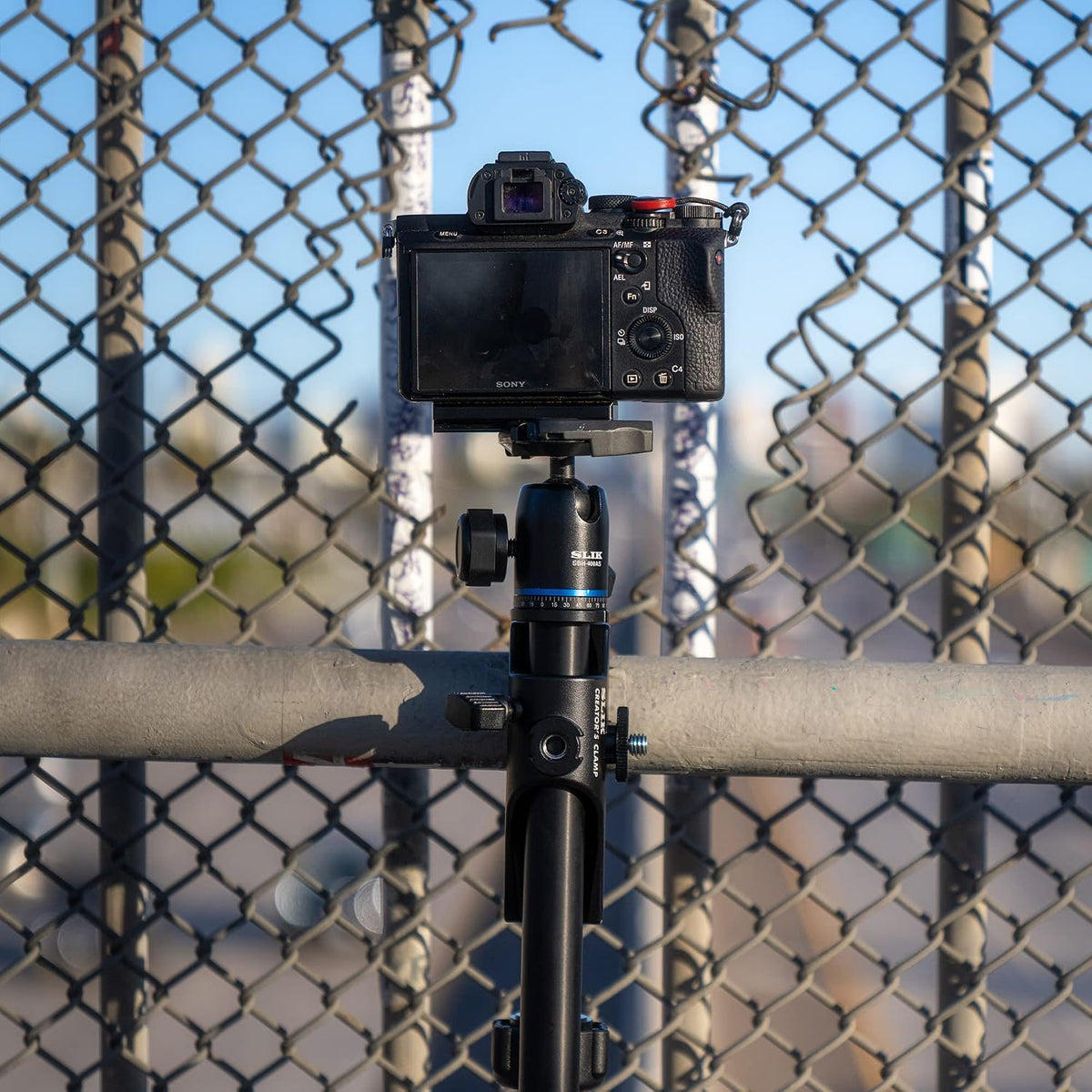Slik Creator's Clamp attached to vertical fence pole setup