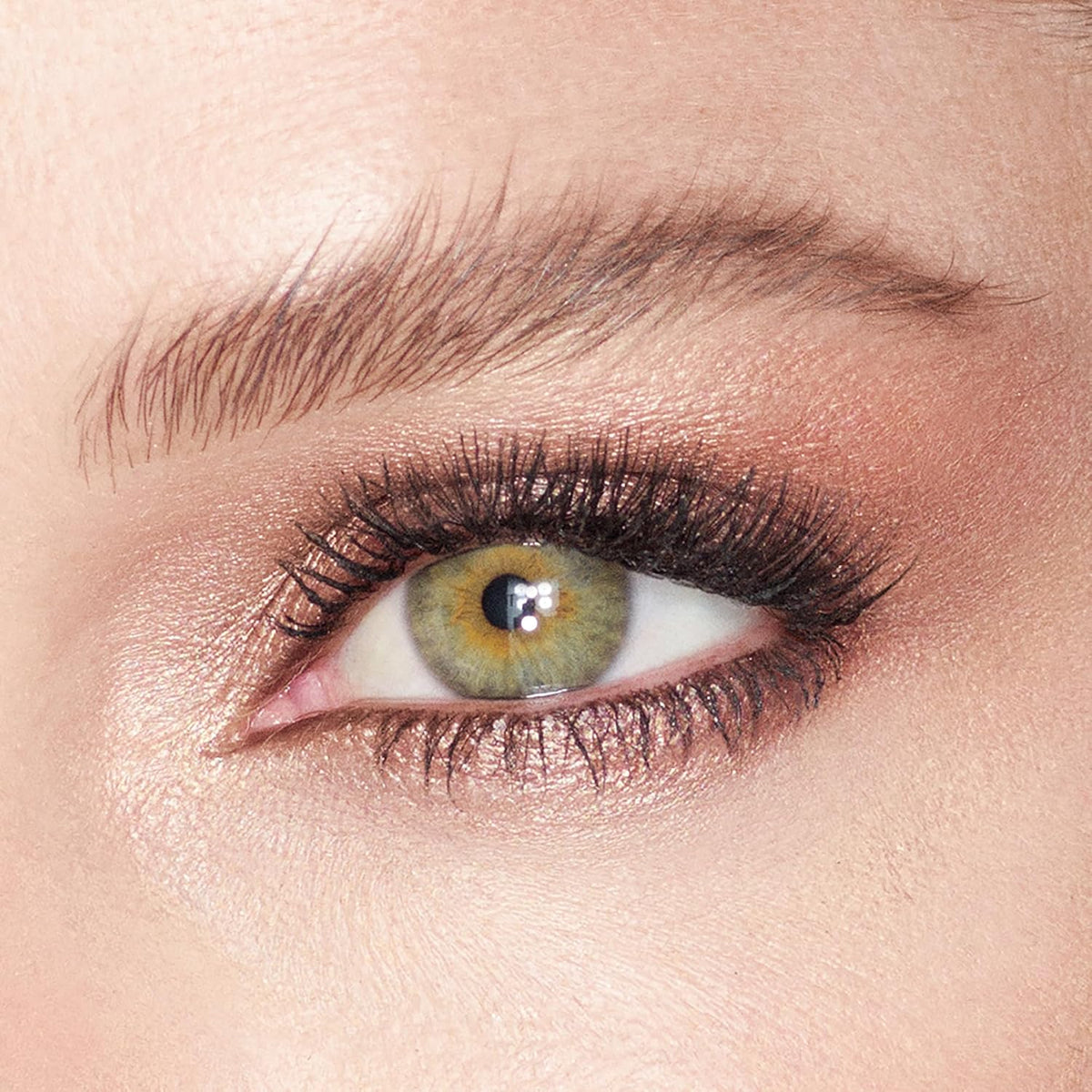 Open jar of Charlotte Tilbury Champagne cream eyeshadow showing texture