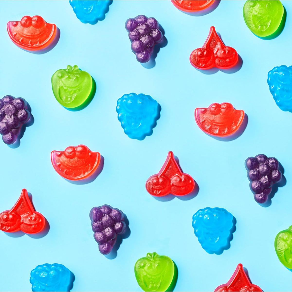 Premium snack table setup featuring a glass bowl filled with vibrant mixed fruit gummies