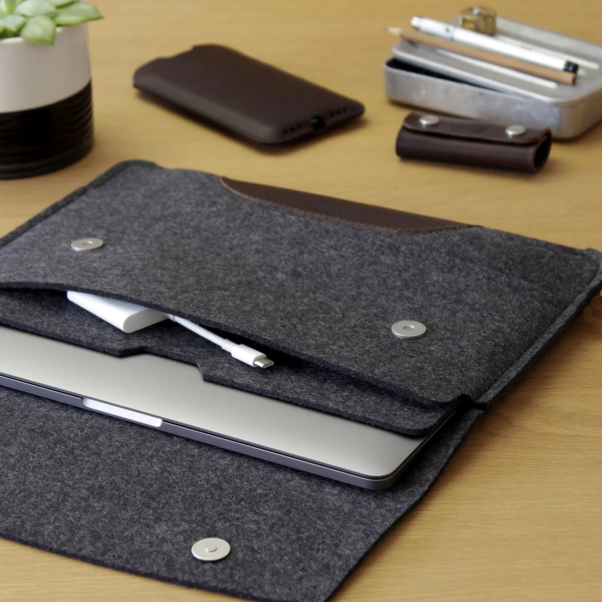 Pack And Smooch MacBook Pro case resting on a wooden desk