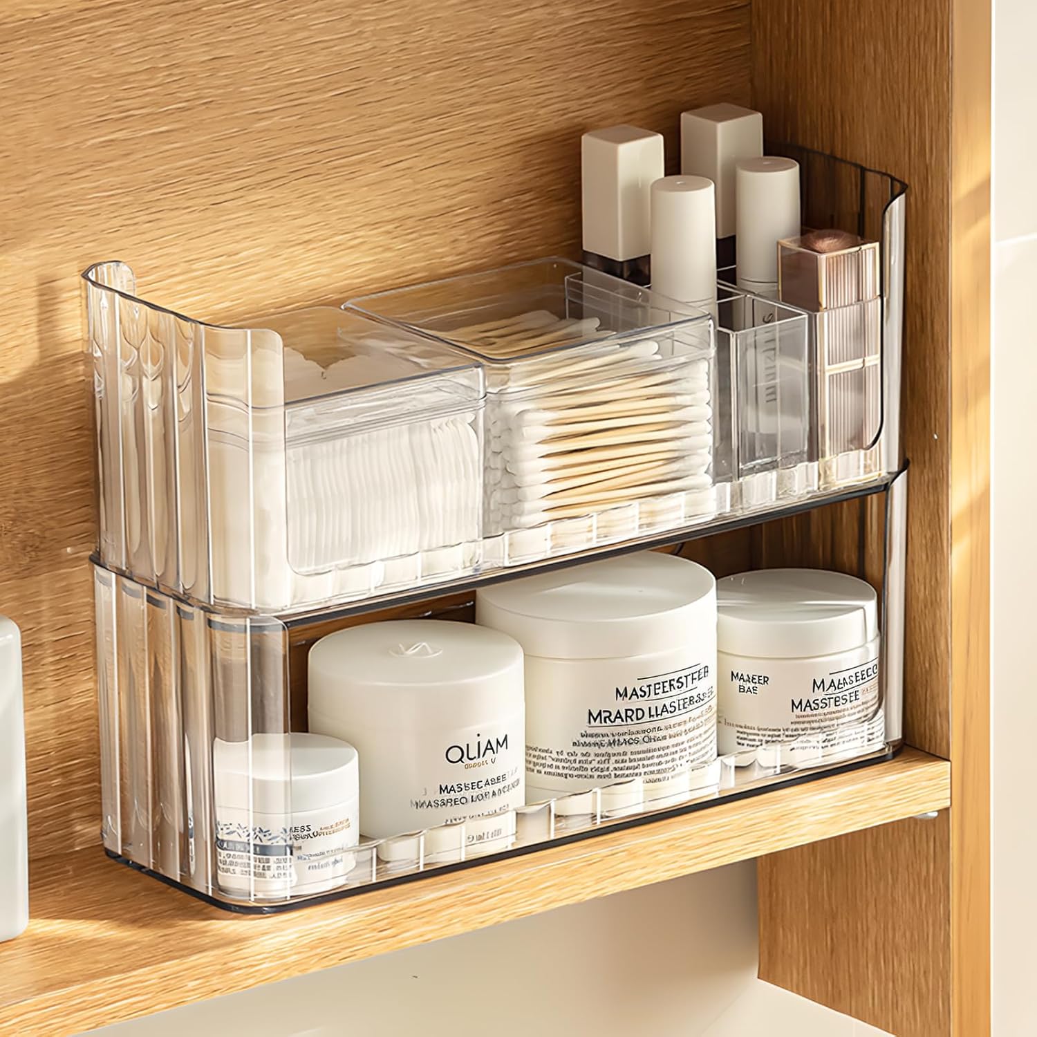PAVSTINE 2-Tier Stackable Medicine Cabinet Organizer front view displaying clear plastic shelves filled with skincare products.
