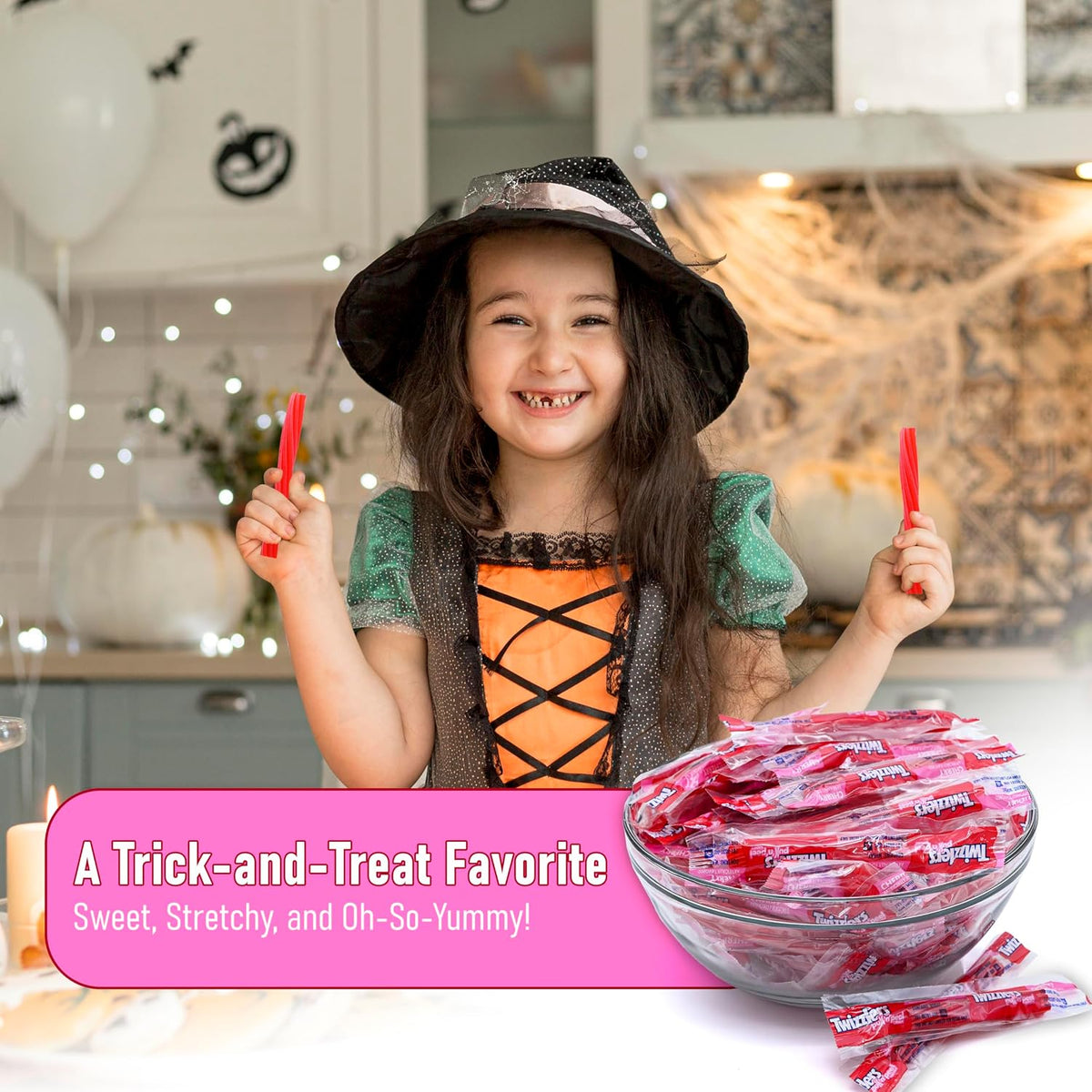 A close-up view of the red cherry flavored licorice candy strands being pulled apart.