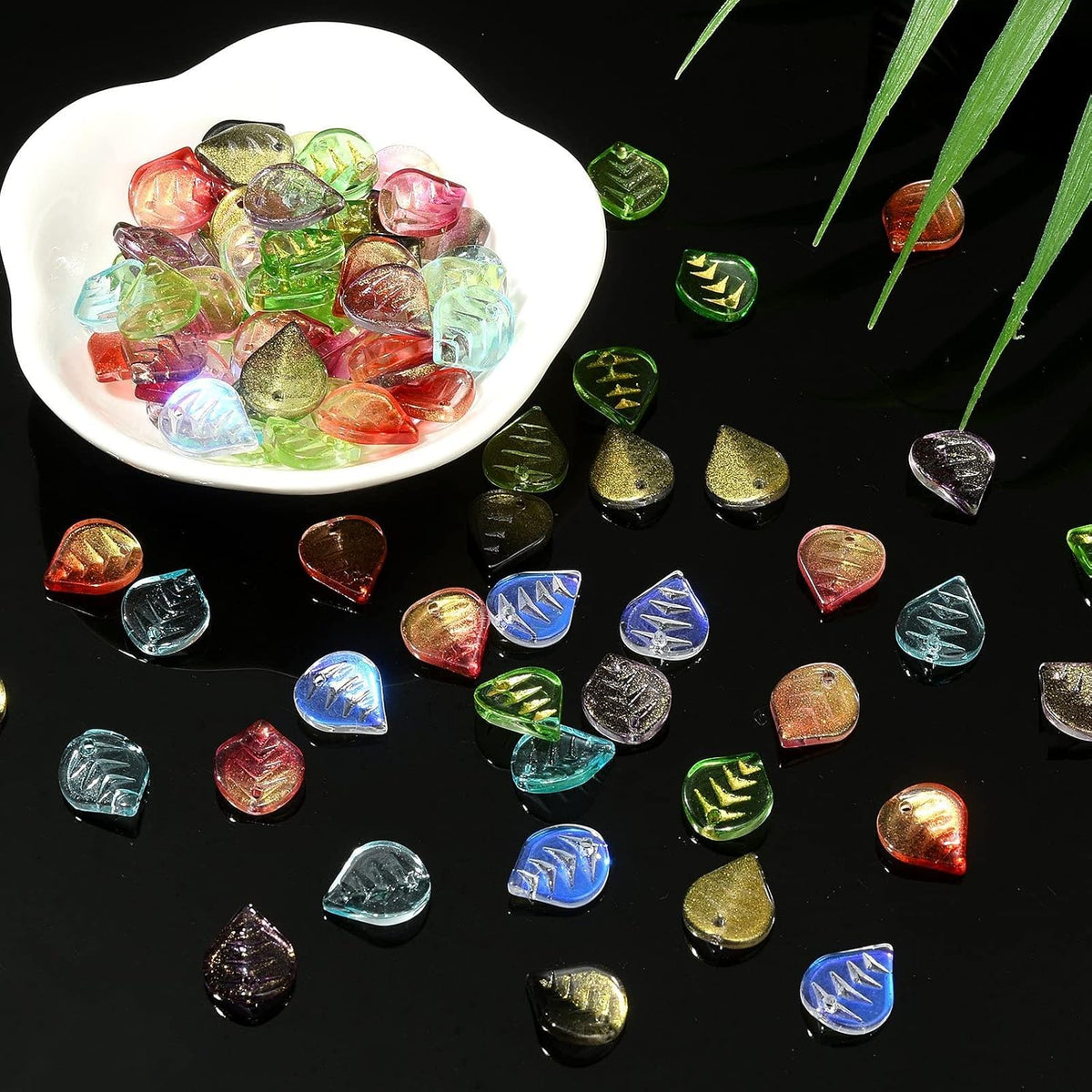 Sparkling gold glitter flakes embedded in glass leaf charms