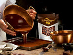Crunchy roasted espresso beans coated in rich milk chocolate closeup shot