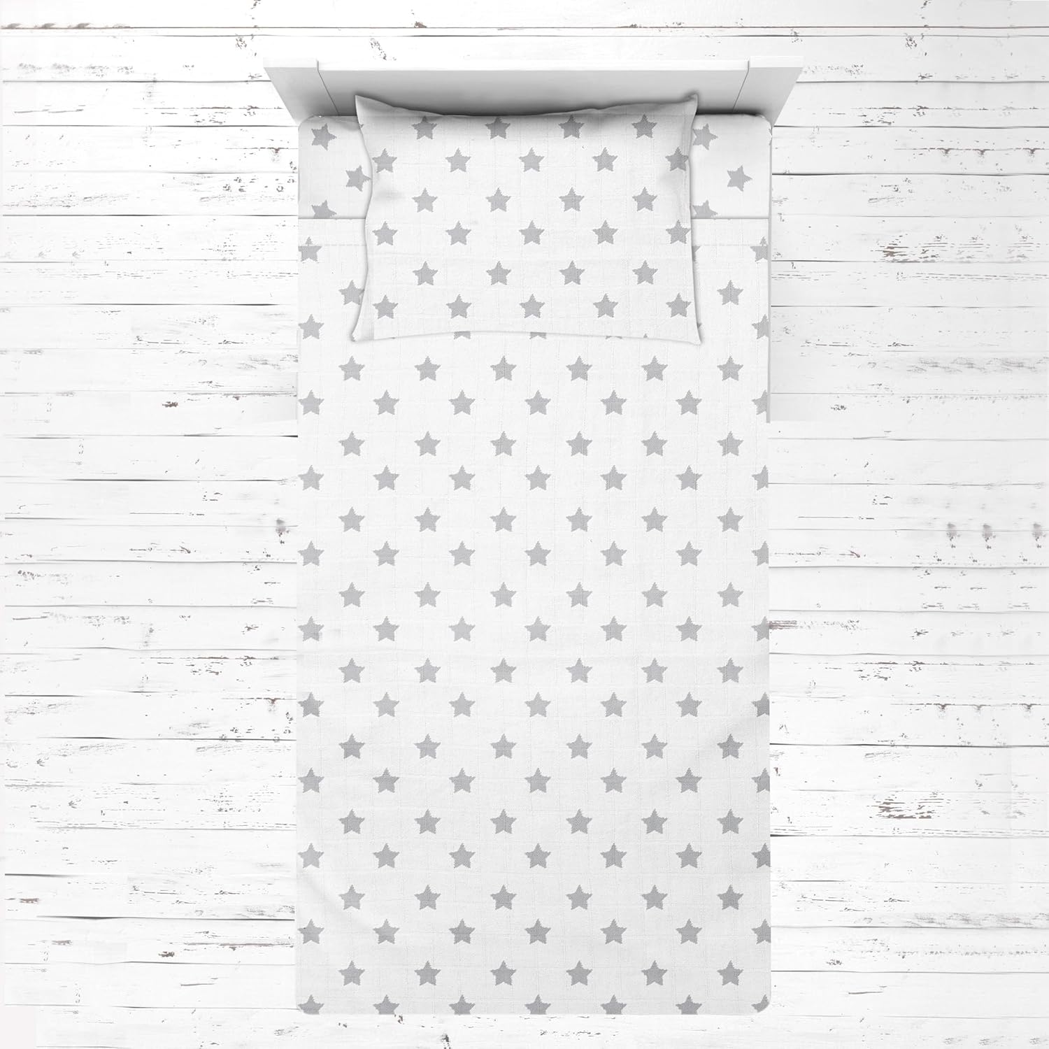 Bacati Muslin Ikat Stars Toddler Bed Sheet Set front view showcase in grey stars pattern.