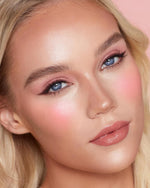 Charlotte Tilbury soft focus matte blush wand showing the twist lock mechanism.