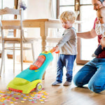 Child pushing Battat Clean n Sing vacuum in room