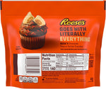 Individually wrapped Reese's white creme peanut butter miniatures scattered outside the orange packaging.