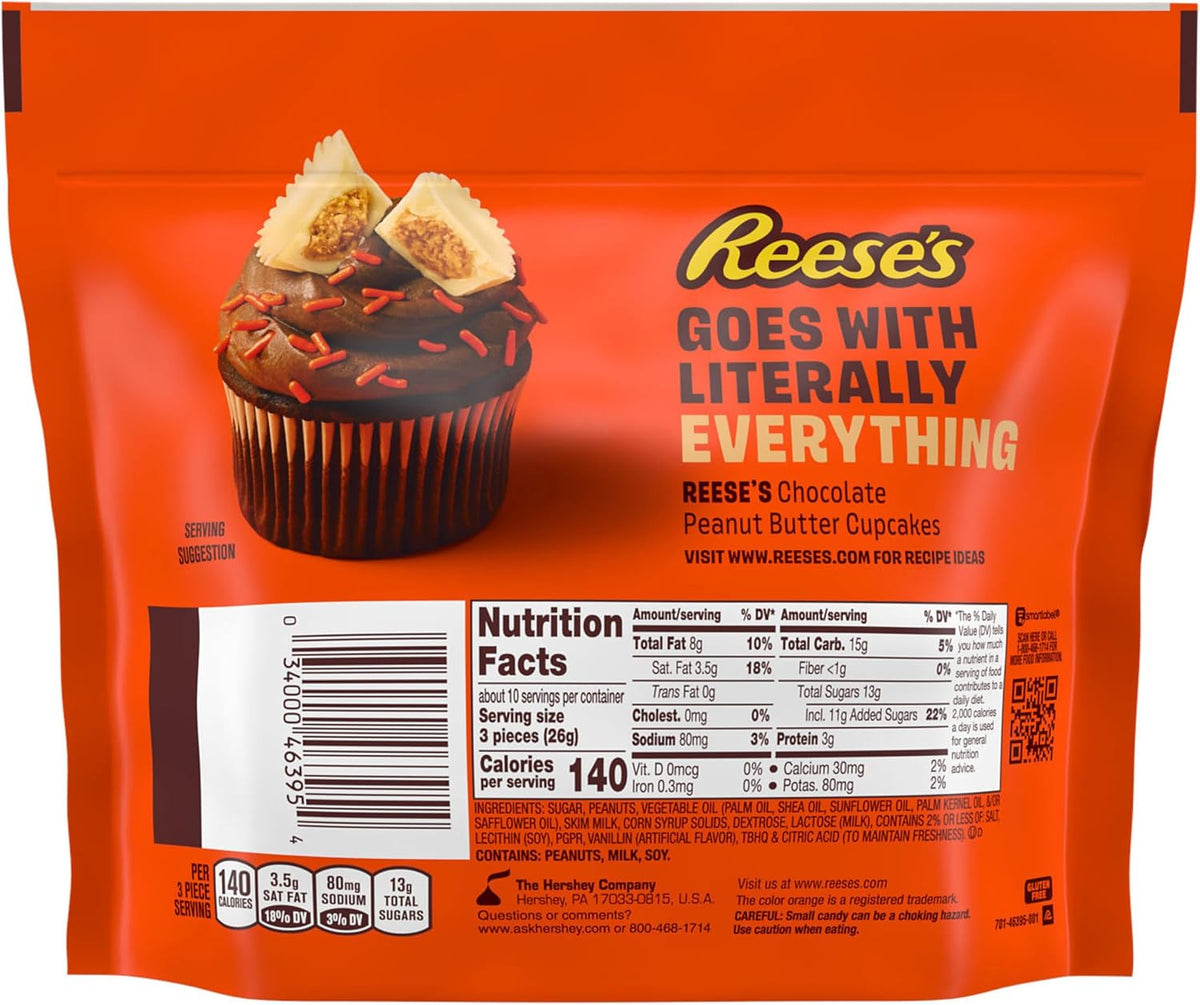 Individually wrapped Reese's white creme peanut butter miniatures scattered outside the orange packaging.