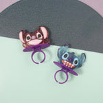 Blue raspberry and strawberry flavored hard candy rings being used as decorative cupcake toppers.
