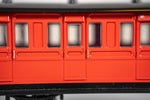 Bachmann red passenger coach positioned on HO gauge track