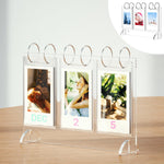 WINKINE Instax Mini Photo Album front view showing clear acrylic calendar stand on a wooden desk