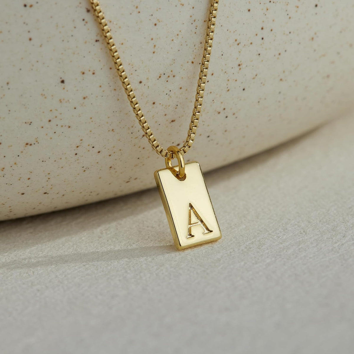 Comparison display of gold and silver finish options for the necklace