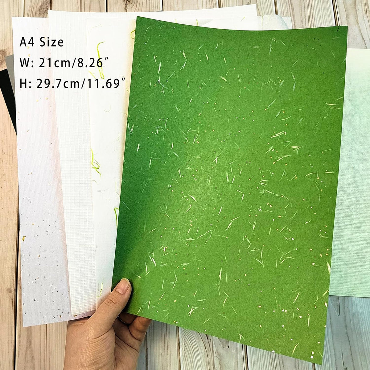Assorted earth and botanical tone scrapbook papers laid flat