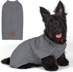 A large dog comfortably walking outdoors at dusk wearing the reflective sweater.