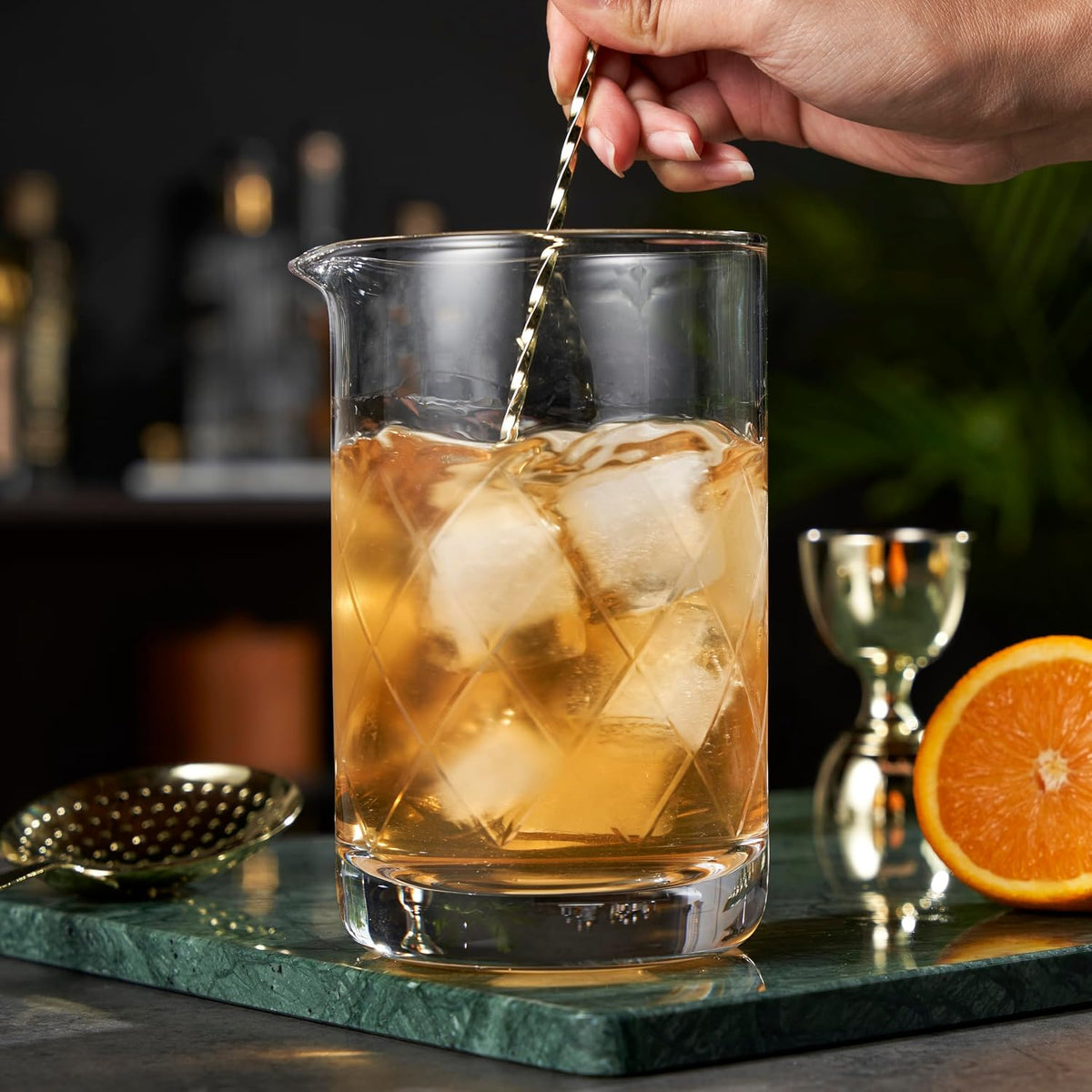 Viski crystal cocktail mixing glass filled with ice and a bar spoon.