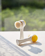 Aprilskin manual pore cleaning brush standing upright on its hygienic self-standing base.