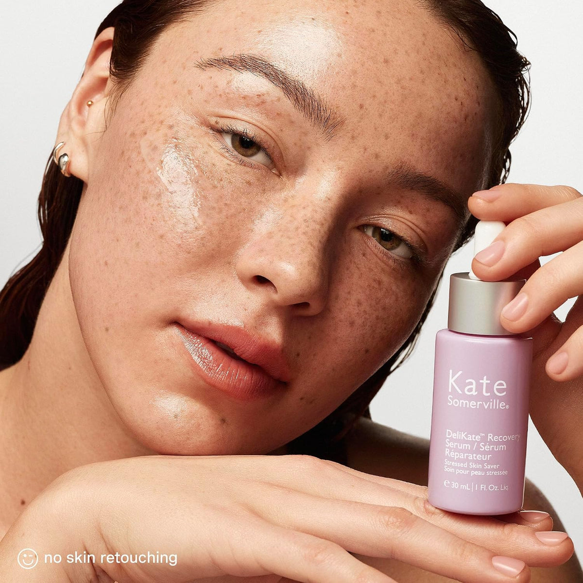 Applying Kate Somerville drops for immediate facial redness relief