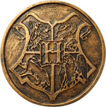Bronze colored Hogwarts Seal on the exterior base