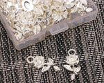 Close up of silver floral pendants for jewelry making