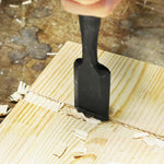 Full length display of the bench chisel resting on a wooden workbench