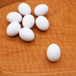 FOIBURELY fake hatching eggs displayed next to a measuring tool showcasing the small parrot scale.