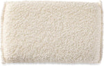 Organic cotton exfoliating sponge displayed for shower use