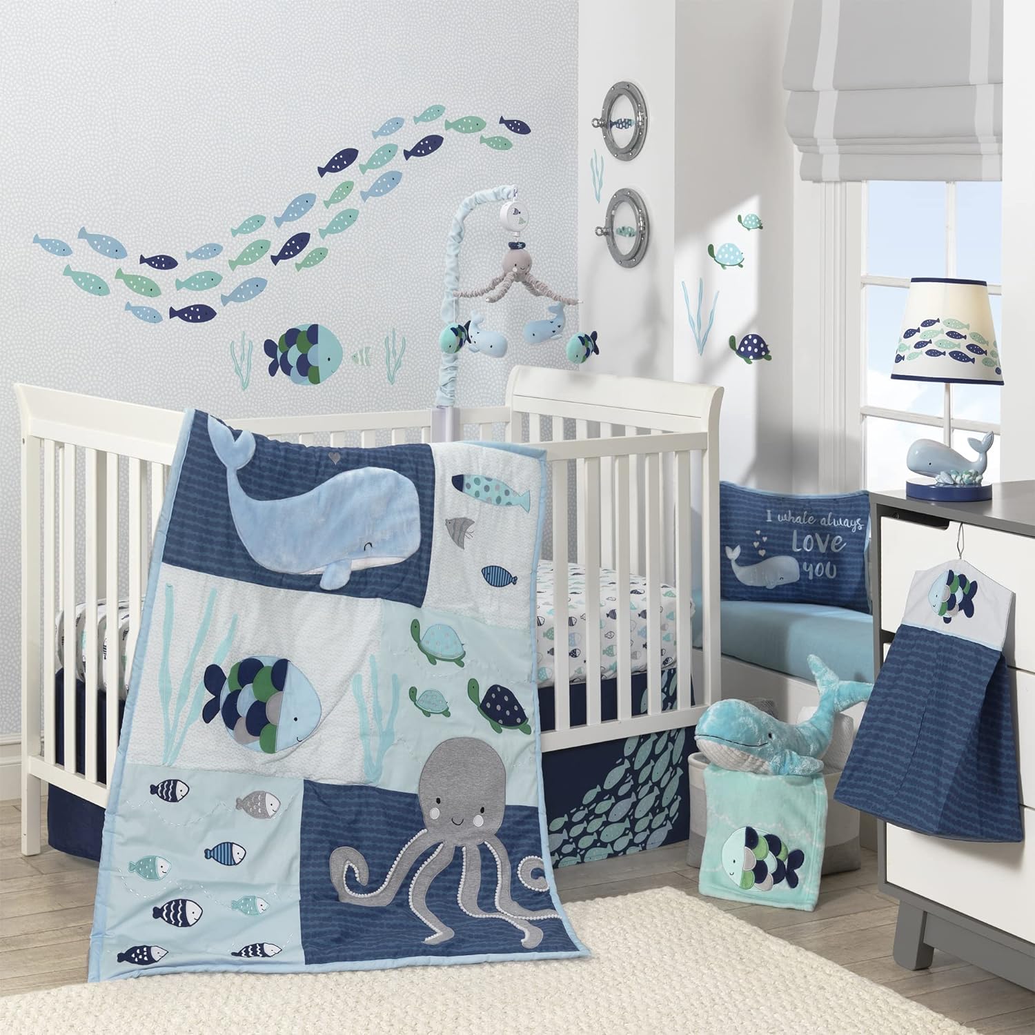 Lambs & Ivy Oceania 6-Piece Baby Crib Bedding Set front view featuring blue and gray patchwork quilt with ocean animals.