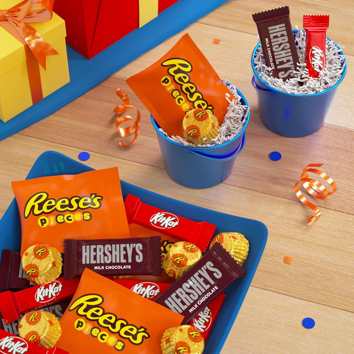 Close-up of individually wrapped Hershey's milk chocolate bars, Kit Kat wafers, and Reese's pieces.