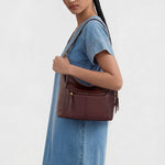 The Sak Alameda leather hobo bag side profile with tassel charm
